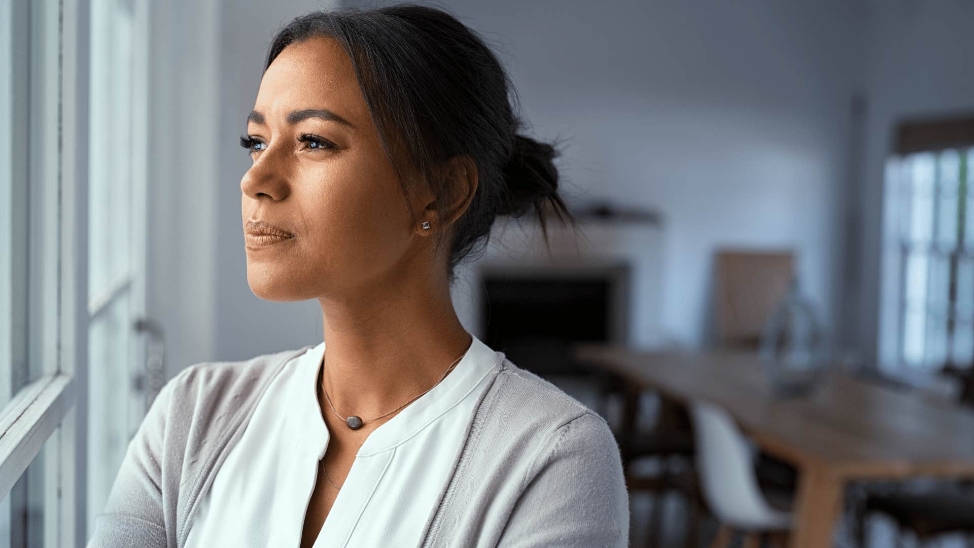 woman looking out window and thinking