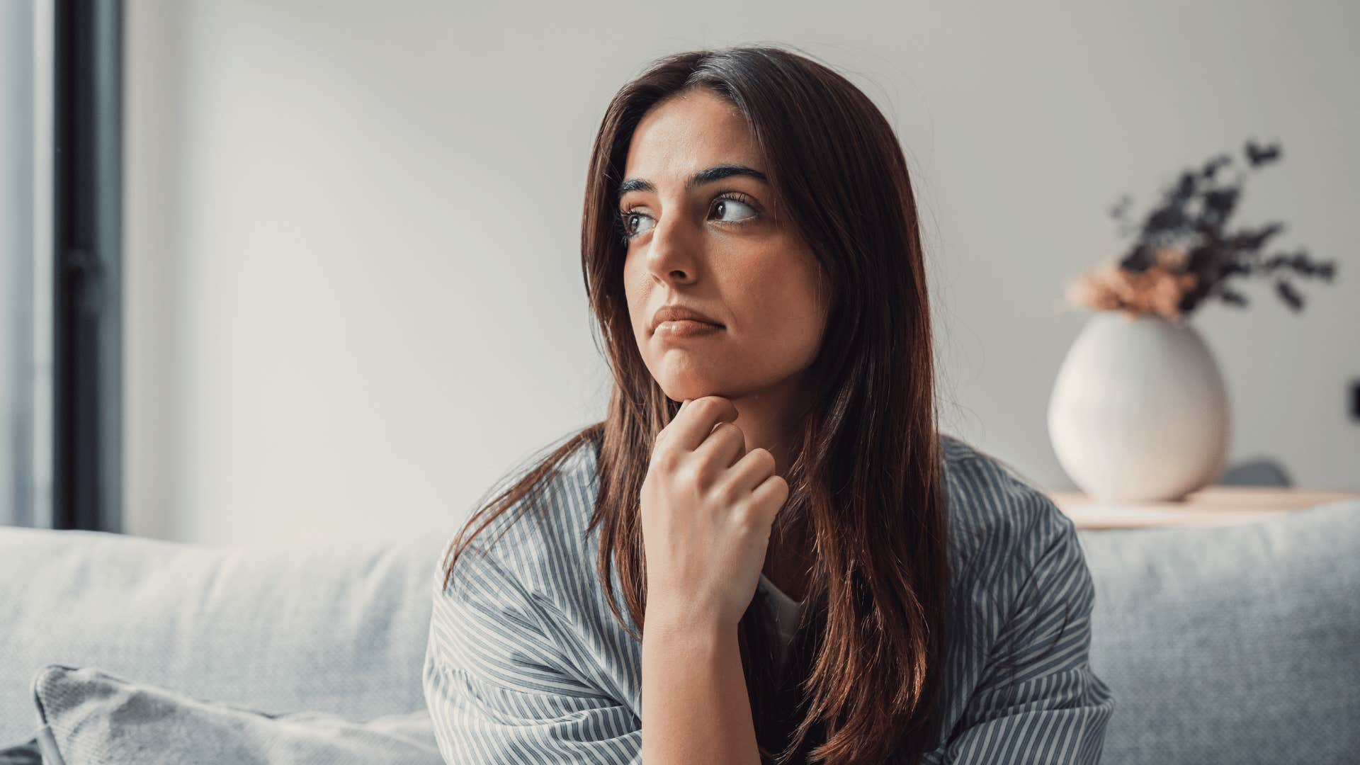 woman thinking and looking outside window