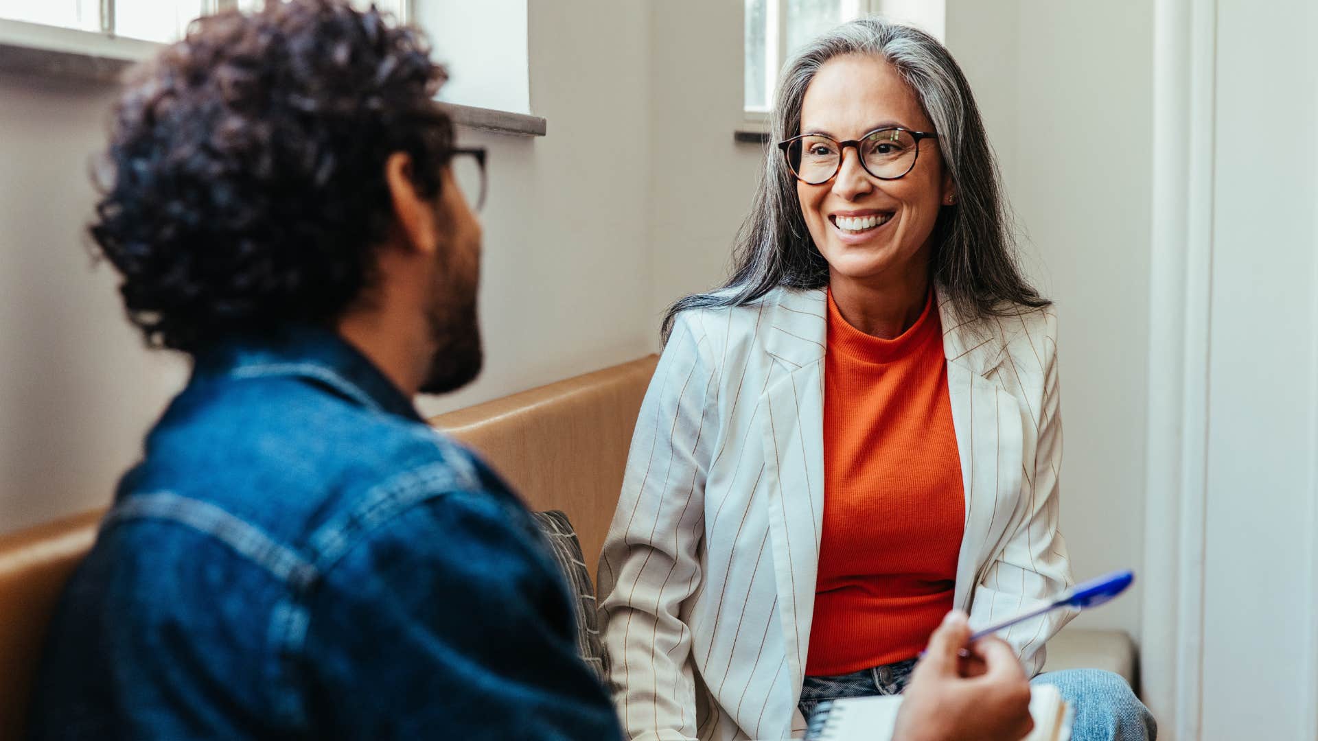 Woman smiling at her co-worker.