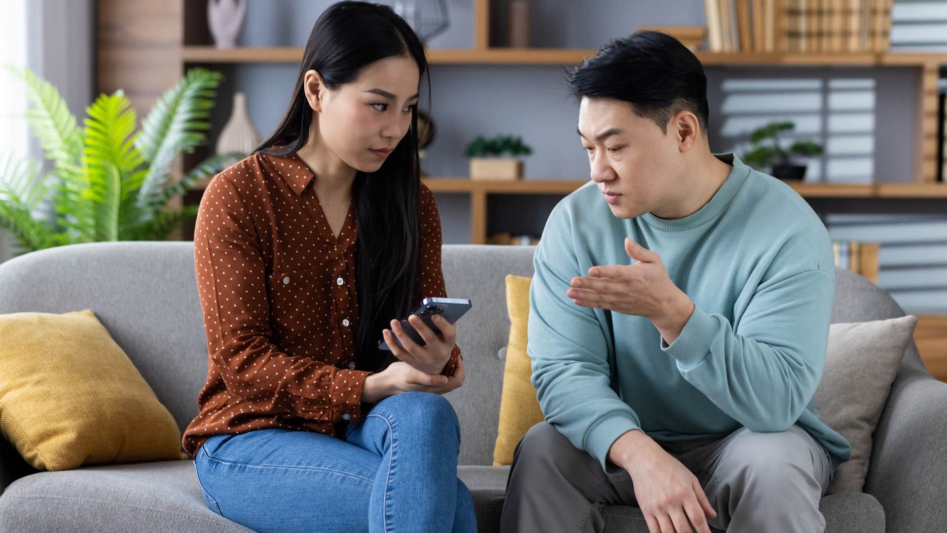 Man arguing with his wife on her phone.