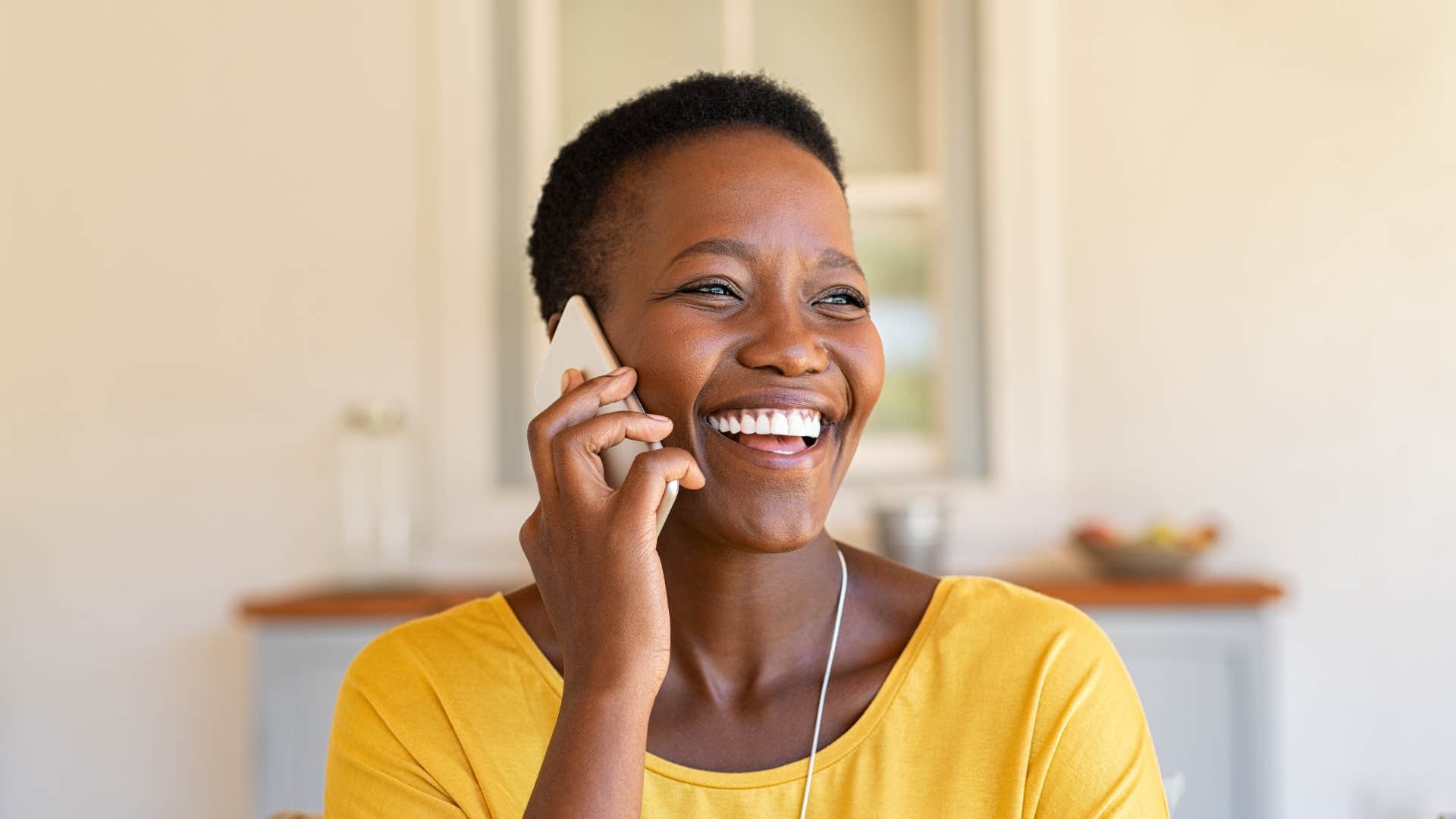 Woman smiling and talking on the phone.