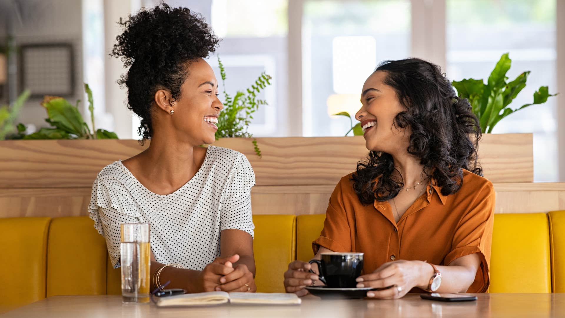 Two women smiling and talking together.