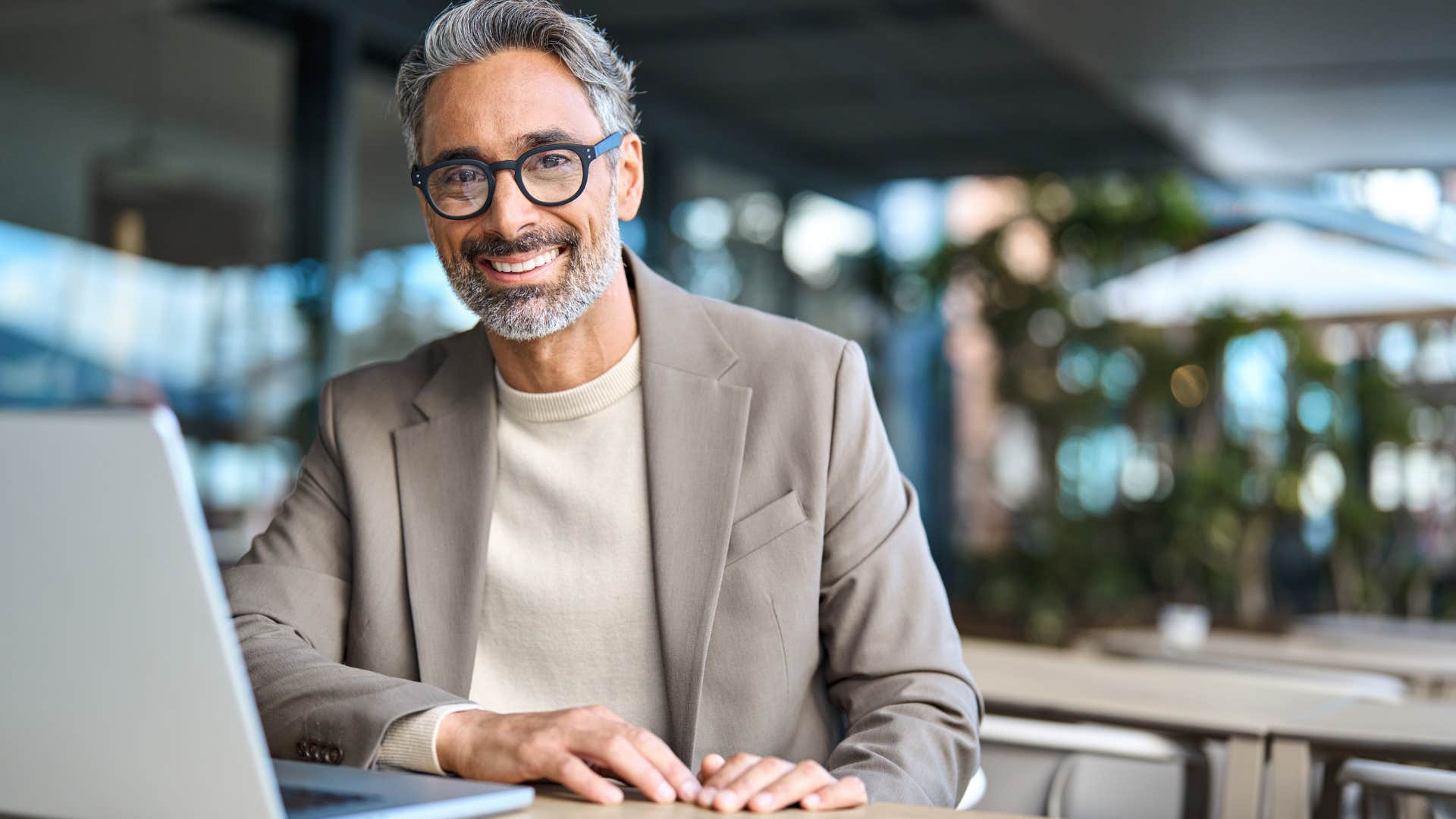 Man smiling at his work desk.