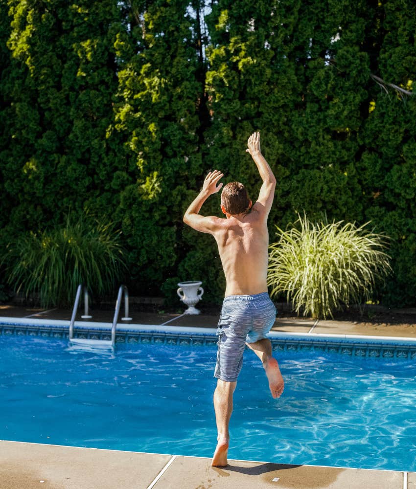 boy jumping in pool