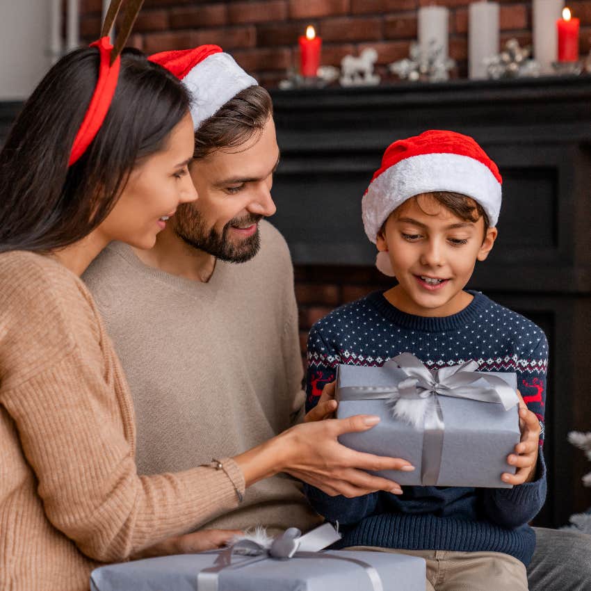 Parents giving their child a Christmas gift