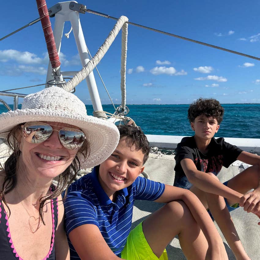 Mom and sons learning lessons on boat about holiday perfection