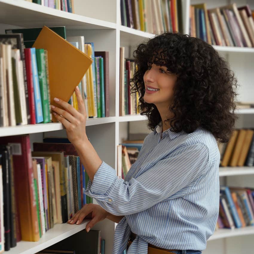 Librarian shelving books