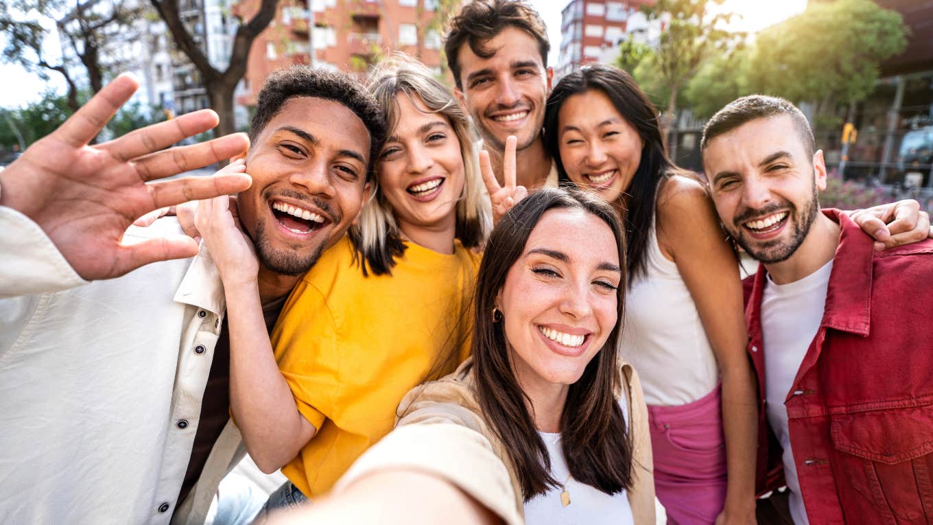 group of millennial friends smiling at camera