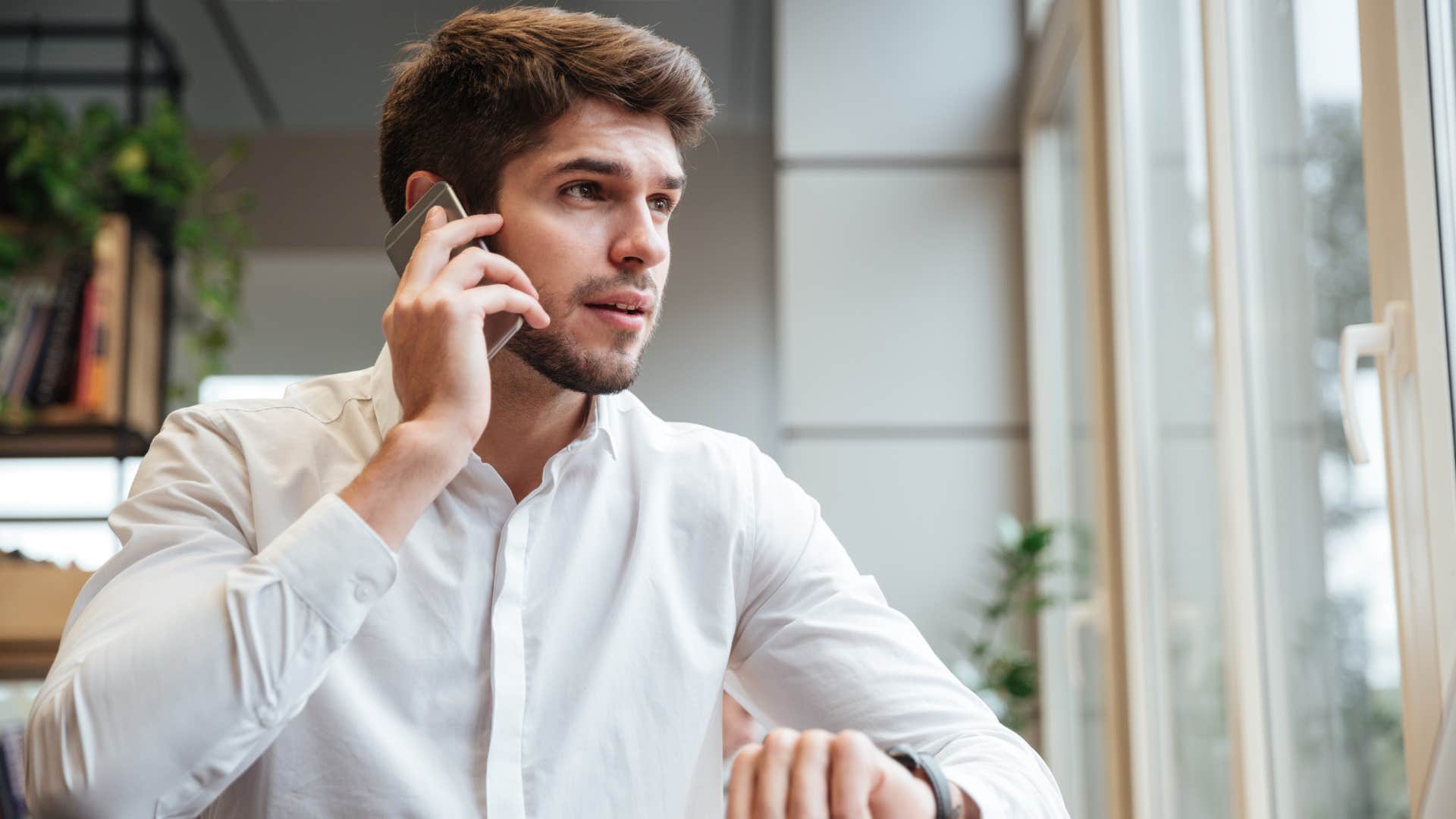 man sitting down talking on phone