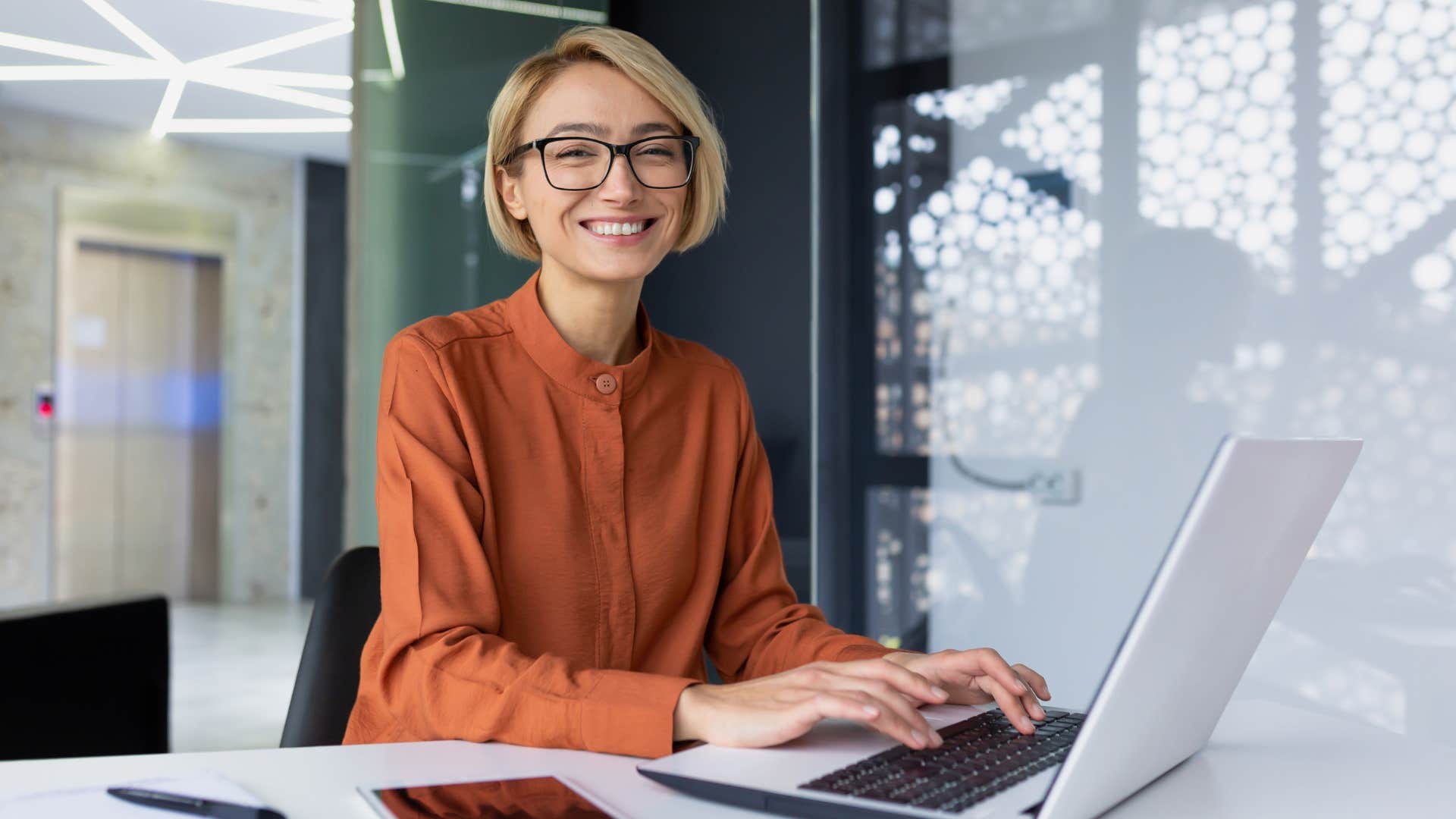 woman sitting at a desk using a laptop