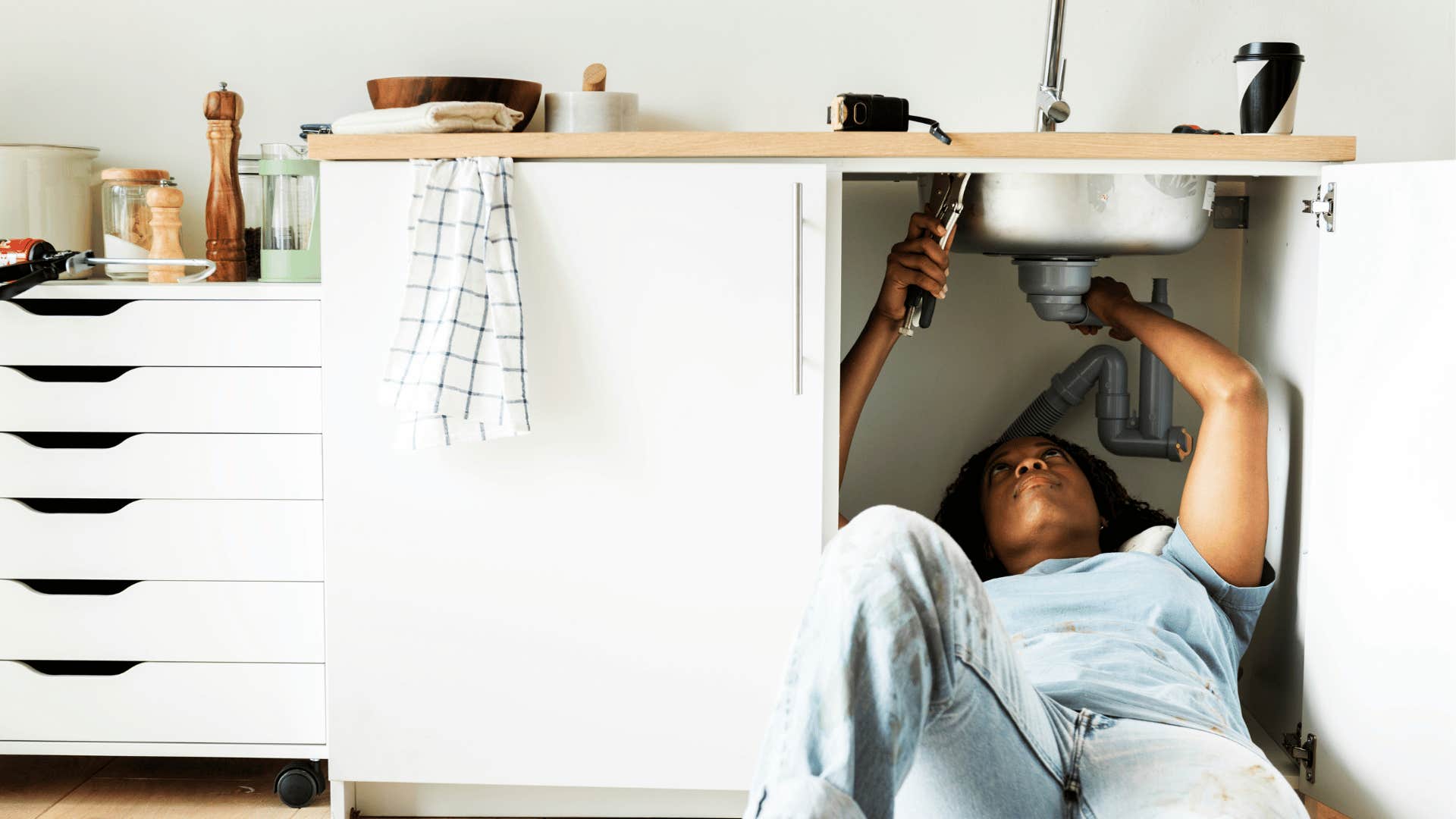 woman fixing a sink