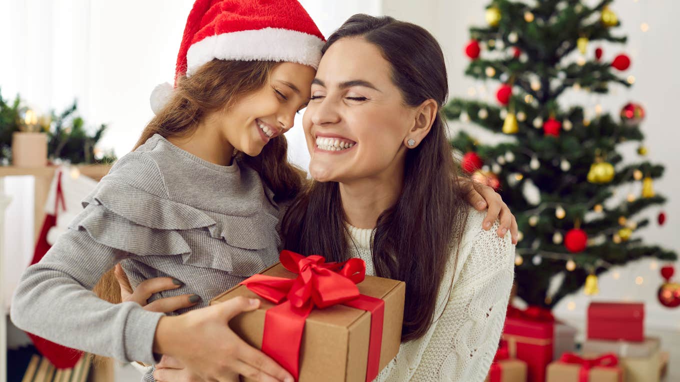 mom and daughter hugging exchanging Christmas gifts