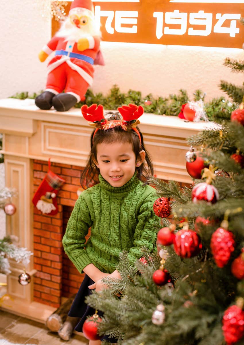 little girl with Christmas tree and decorations