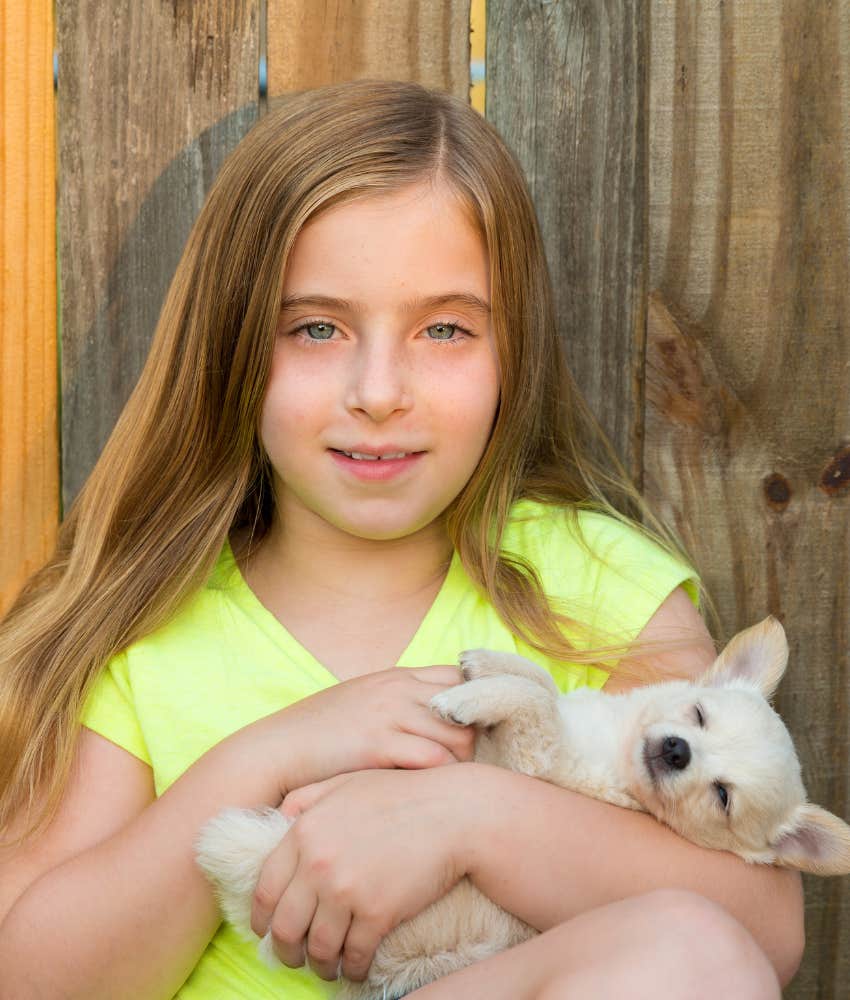 little girl playing with puppy