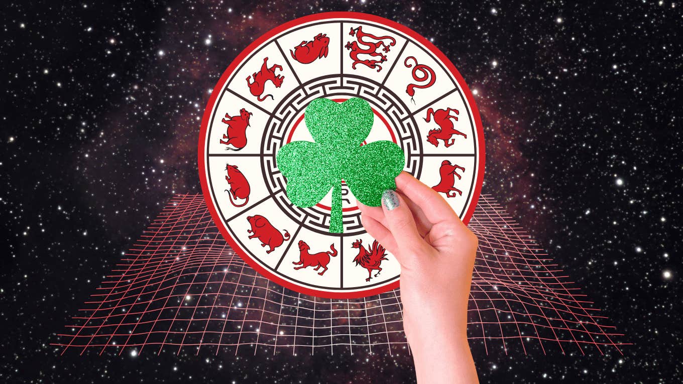 woman's hand holding shamrock for luck good fortune chinese zodiac signs week december 30-january 5