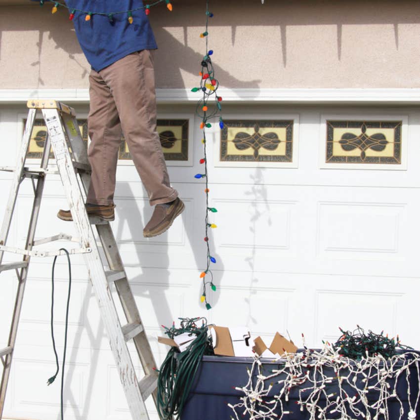 man decorating house for Christmas 