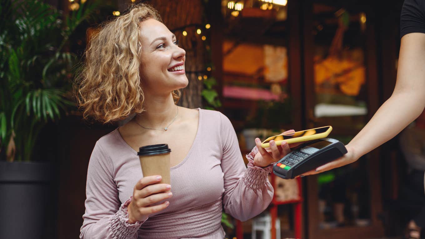 Young woman buying coffee 