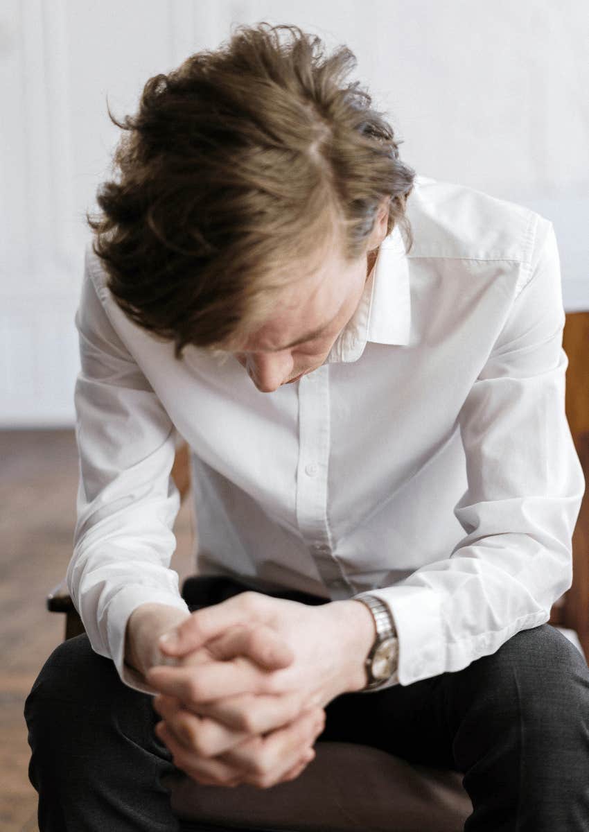 man hanging his head on despair