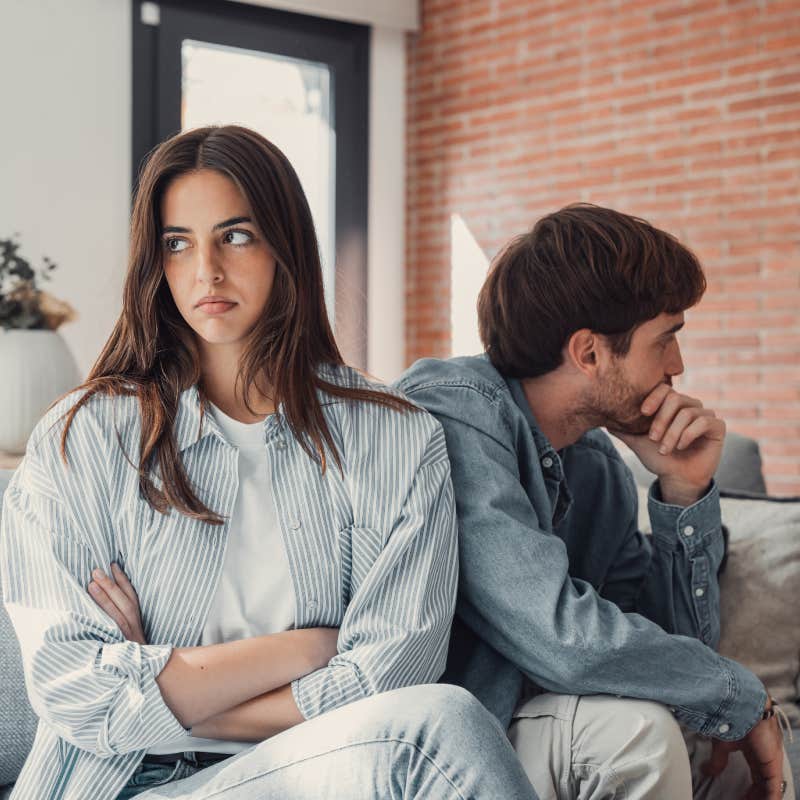 upset couple sitting on couch turned away