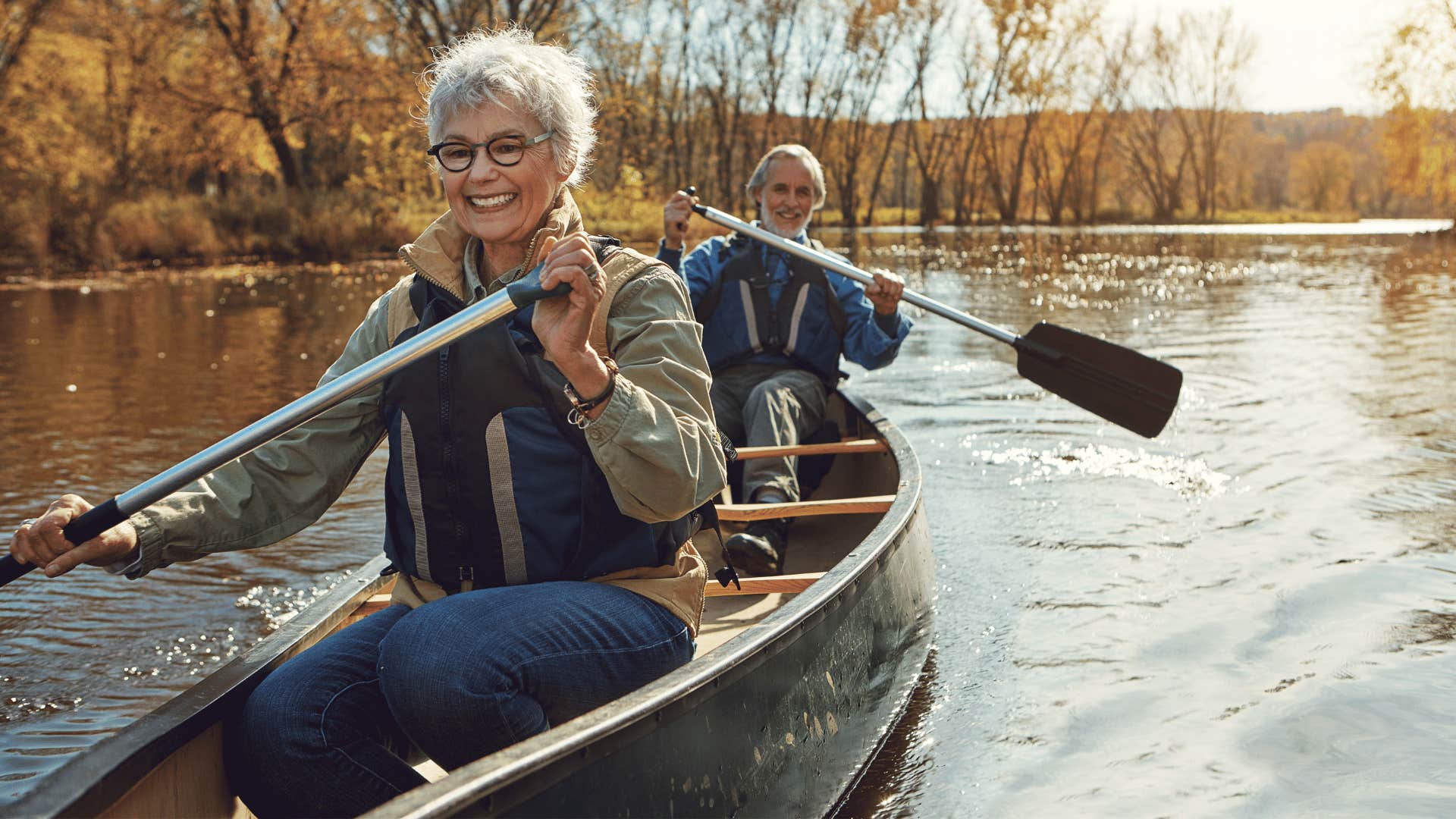 Happy Boomer couple in canoe learned from previous divorce