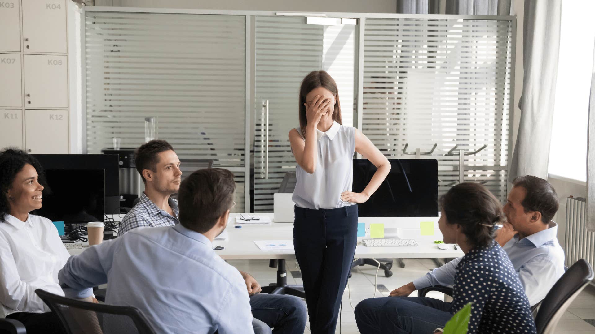 woman embarrassed in front of group of people