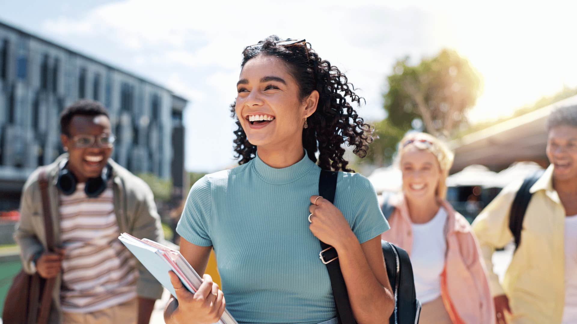 happy smiling woman walking with backpack