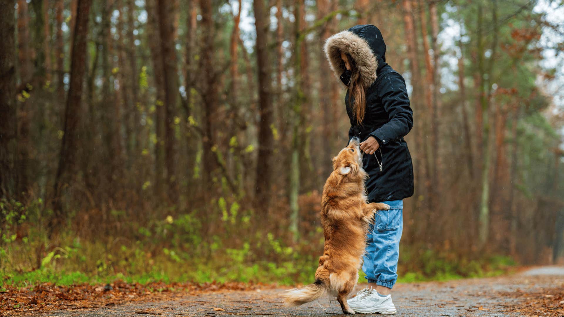 woman playing with dog outside