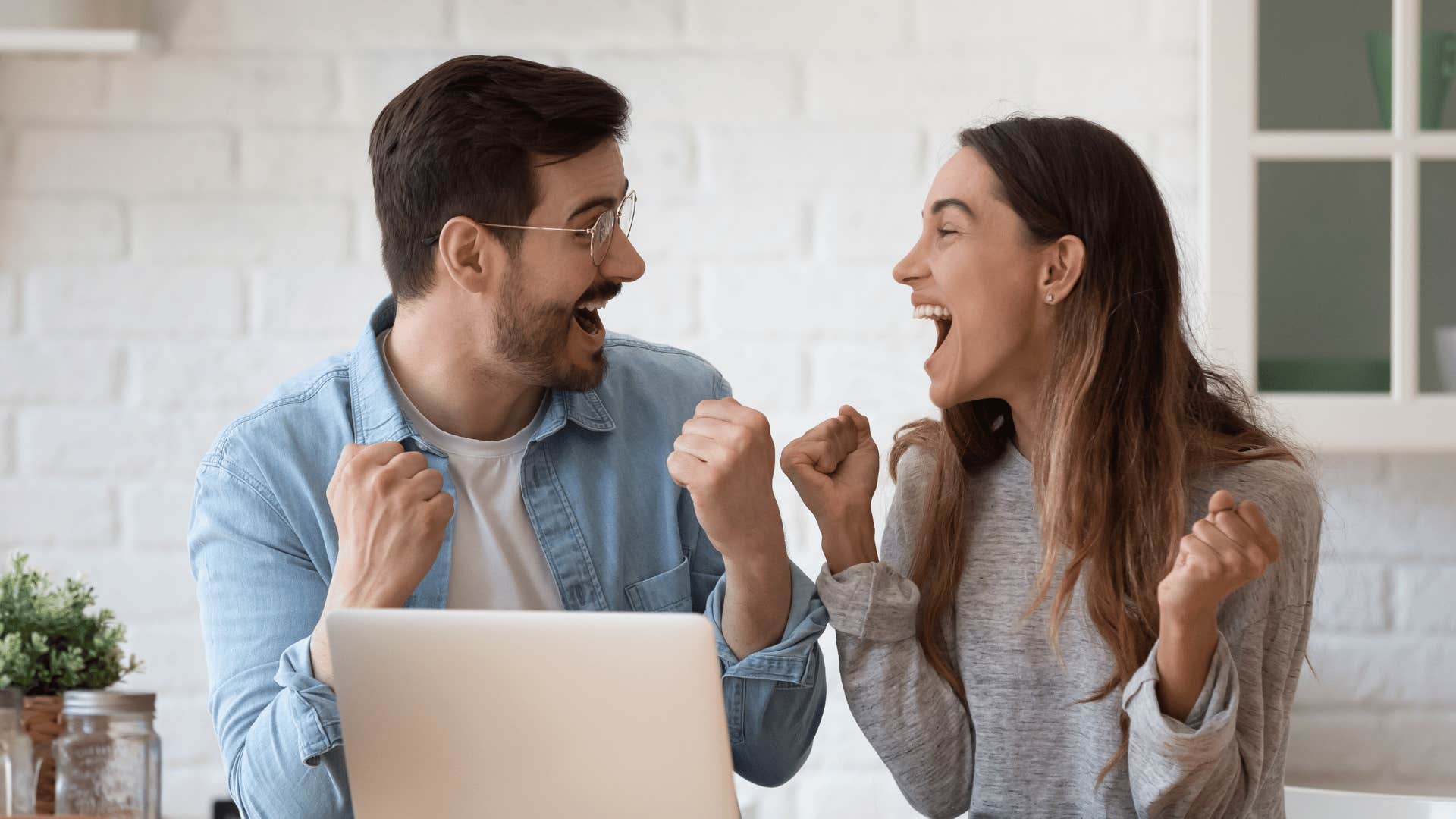 couple excited in front of computer