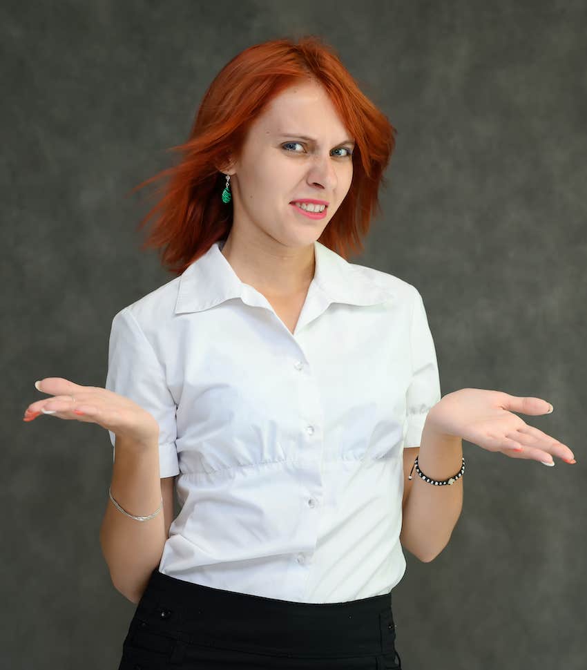 Woman with palms up stops before saying sometheing mean