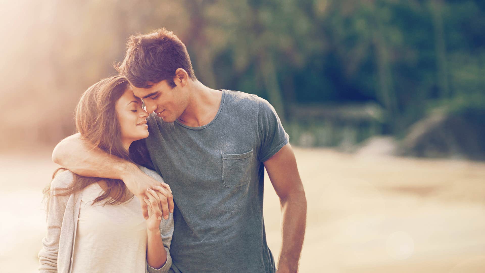 man with his arm around woman