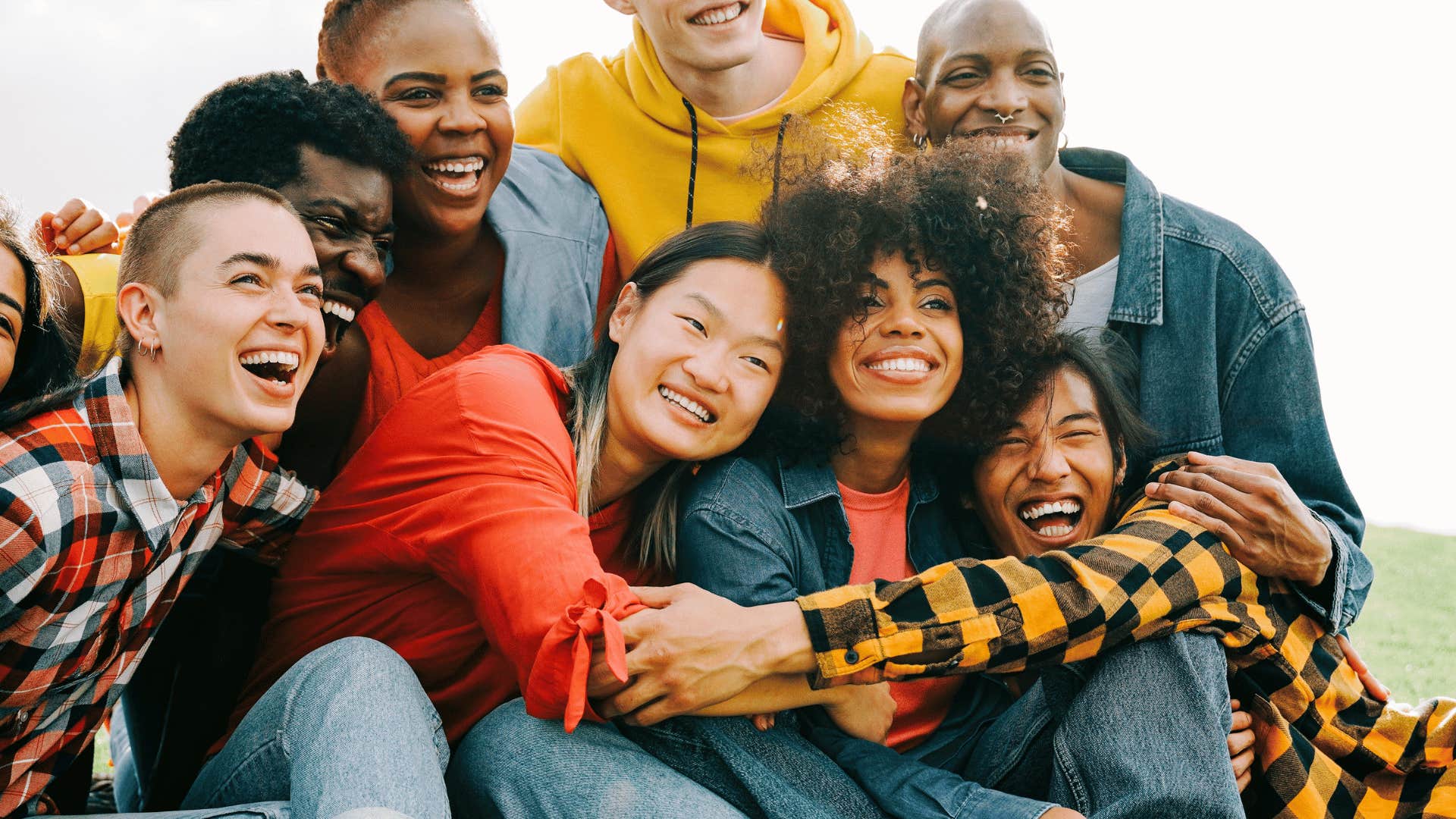 Large group of friends smile and hug with no rush to get married