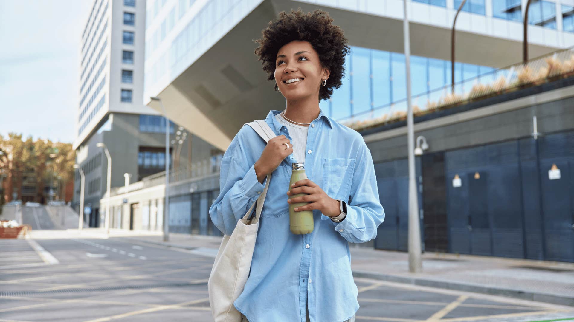 woman carrying a tote bag and water bottle