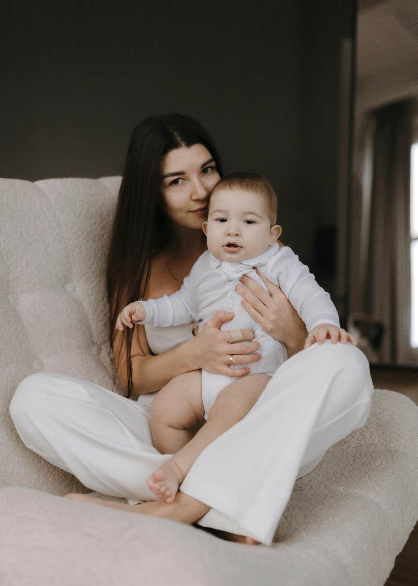 mom sitting on a couch holding her baby