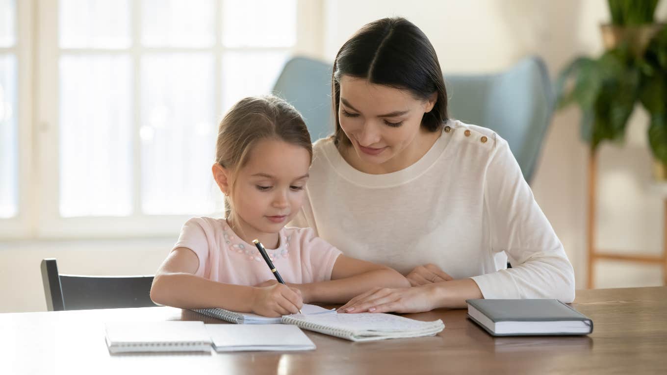 Mom helping her daughter with her homework