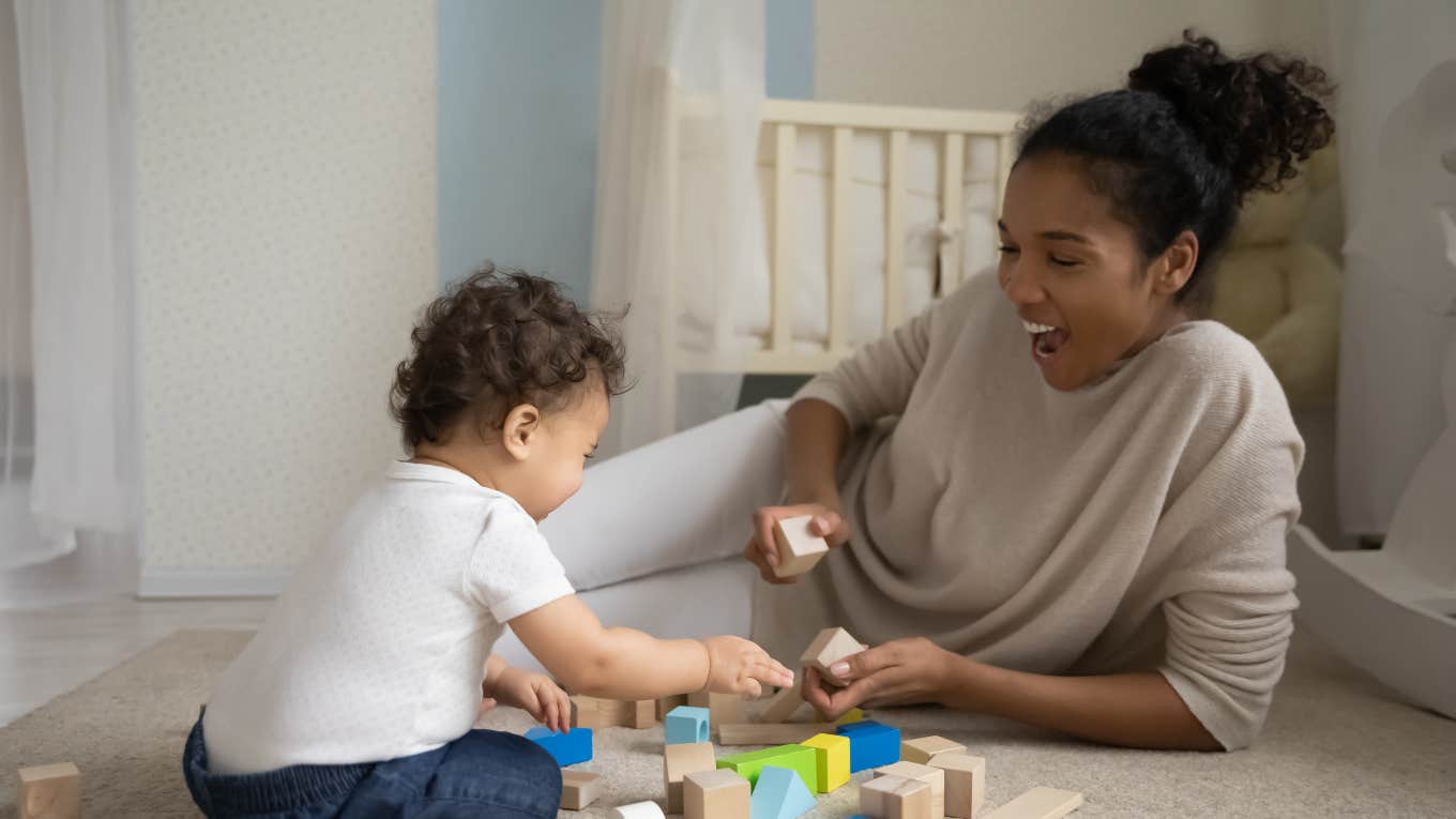 nanny playing blocks with toddler