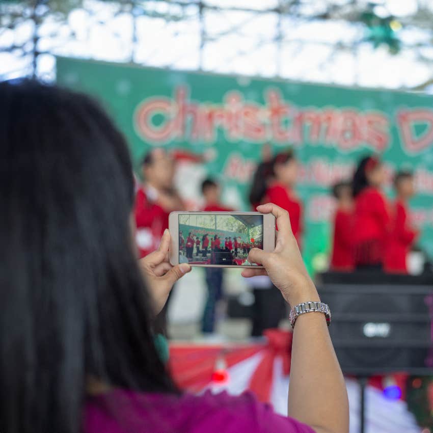 Mom recording her child's school holiday concert