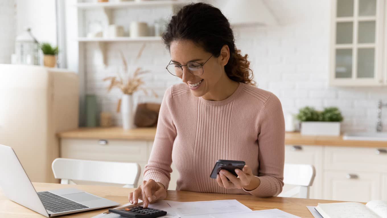 Mom happily looking at how her savings have added up over a year