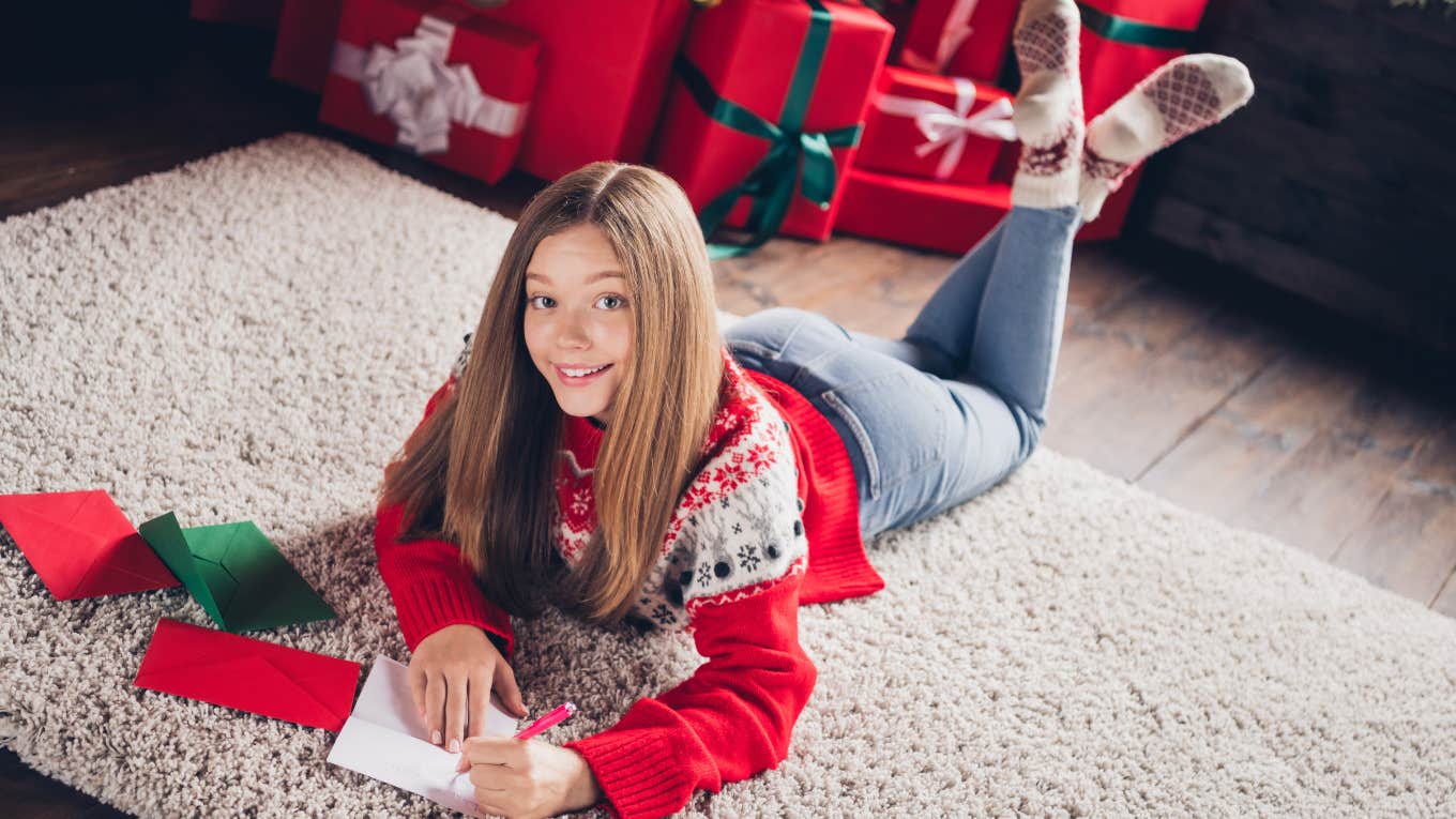 Tween girl writing out Christmas wish list