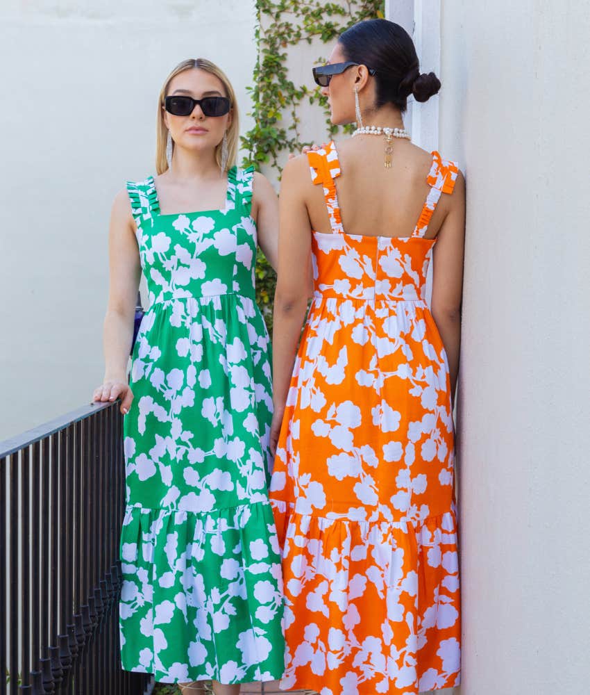 two women dressed in similar floral dresses