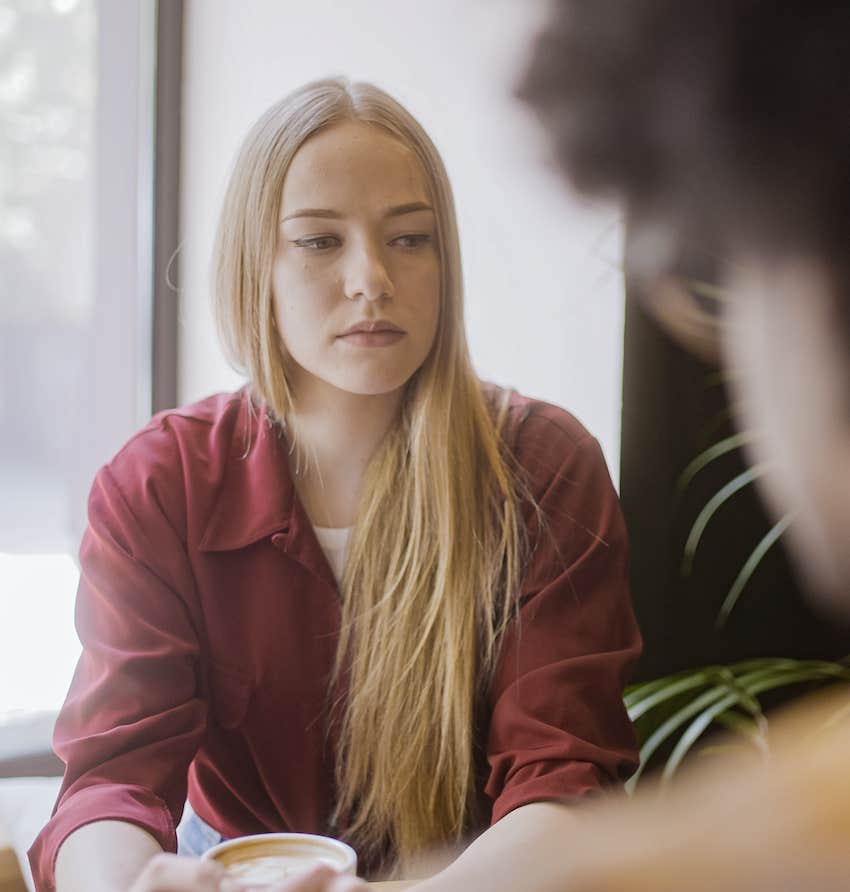 Woman stares blankly with no expression