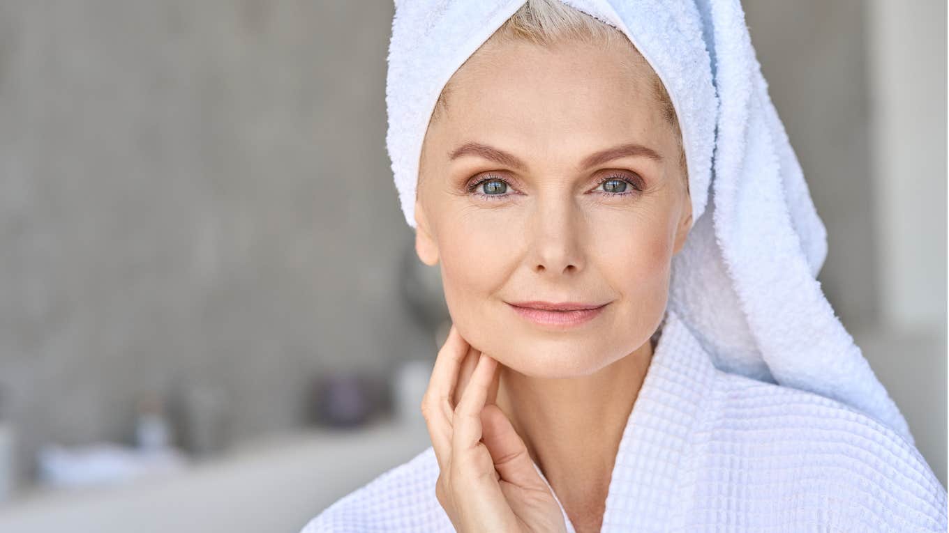 Woman in her sixties getting ready for the day in her bathroom 