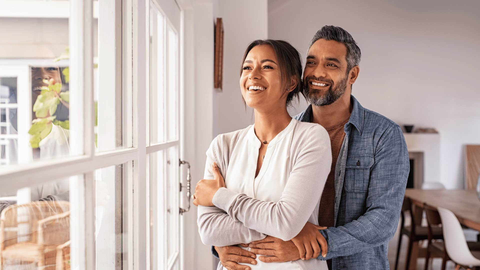 happy couple looking out window