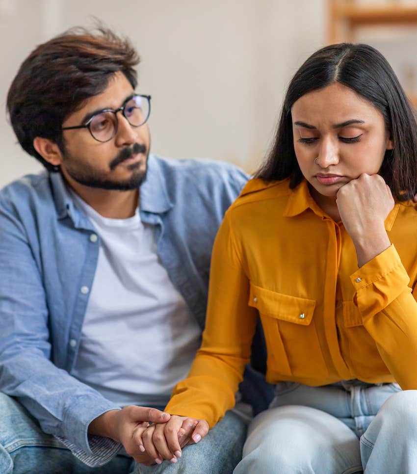 Man comforts self-critical woman