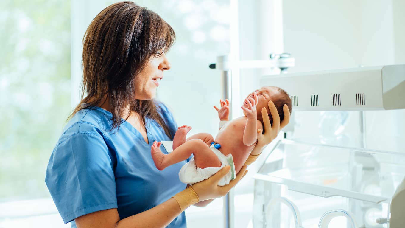 Nurse holding preemie baby