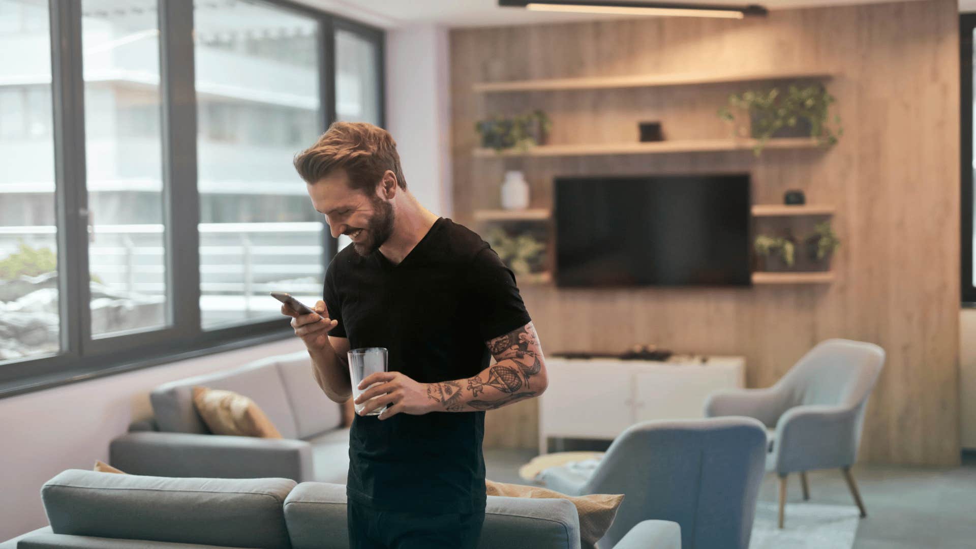 man smiling while on his phone