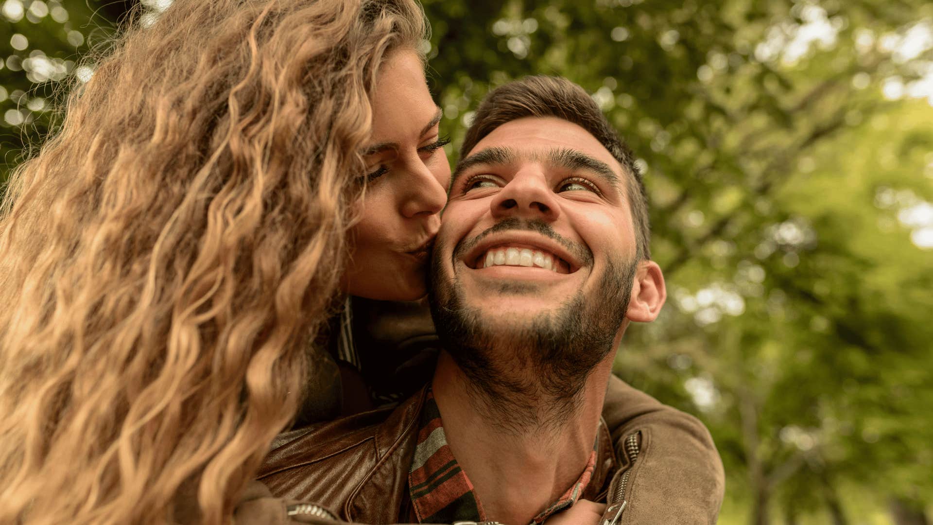 woman kissing man on the cheek