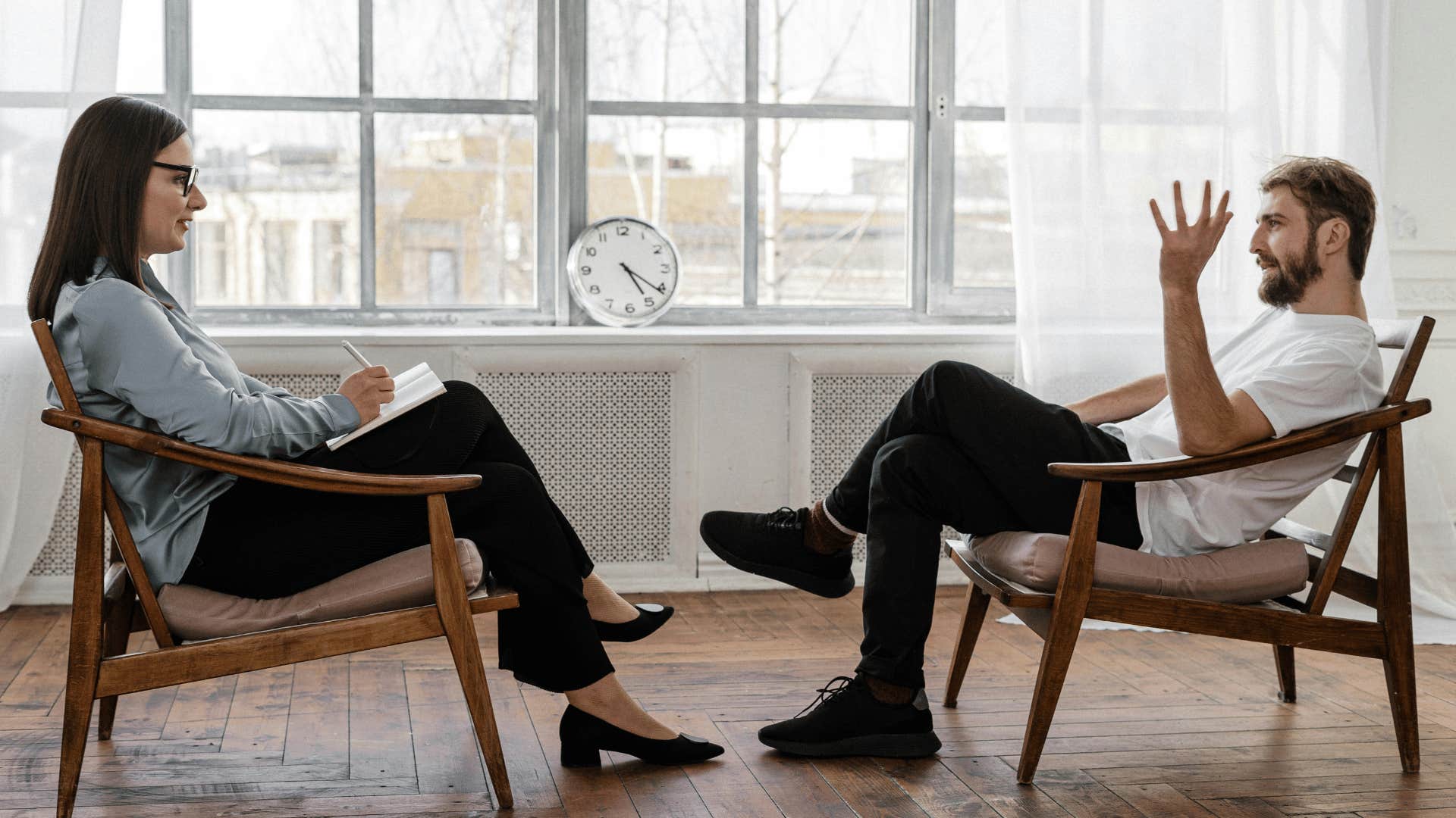 two people sitting across from each other talking