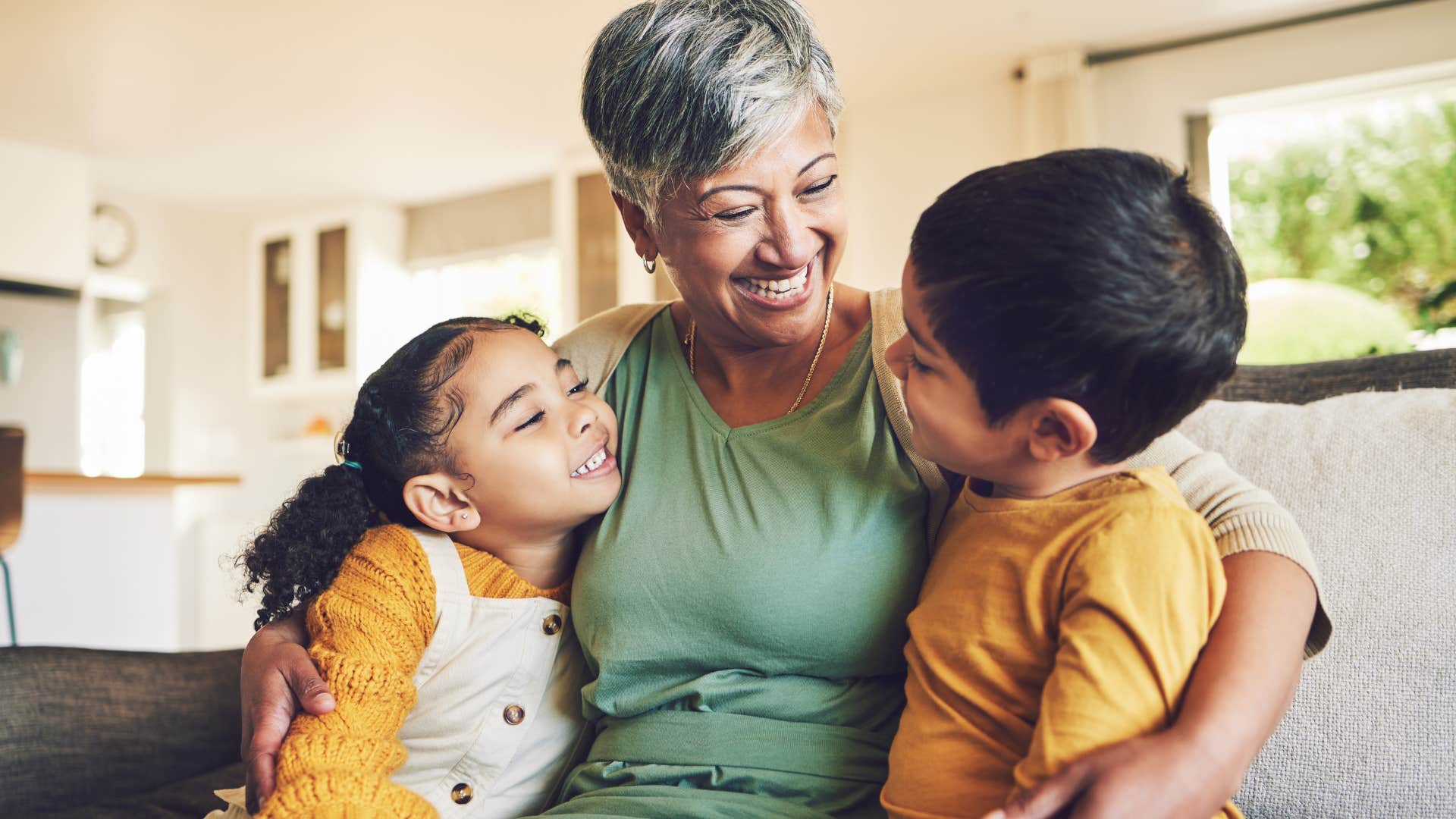 Grandma smiling in between two young kids