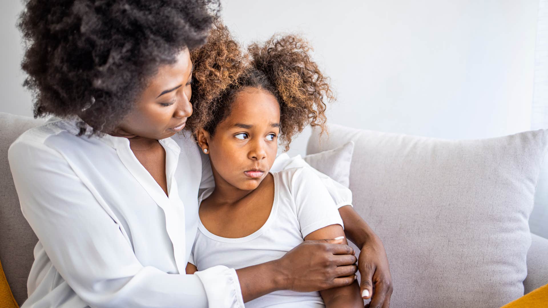 Woman hugging her upset daughter