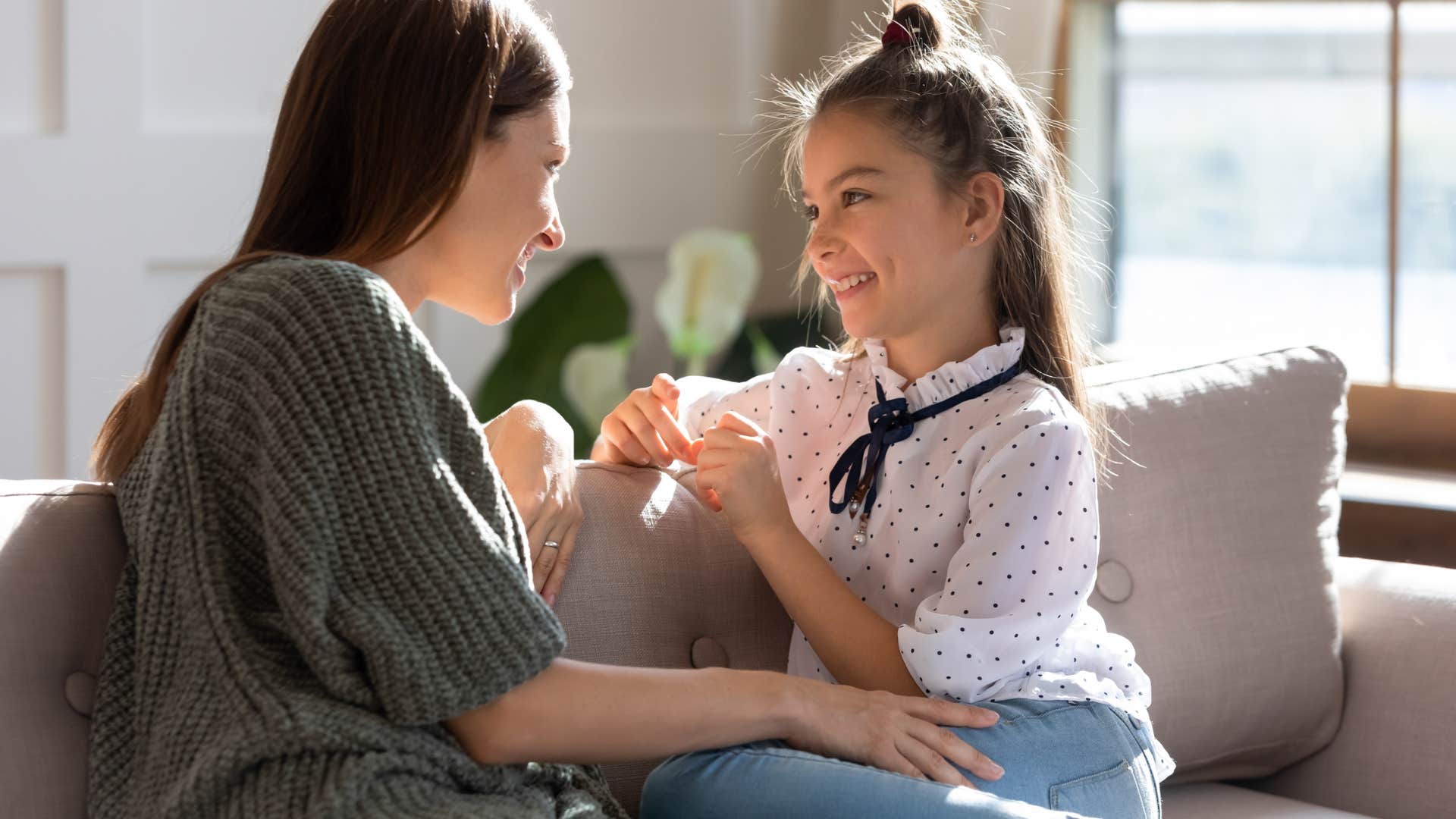 Woman talking to her happy teenager